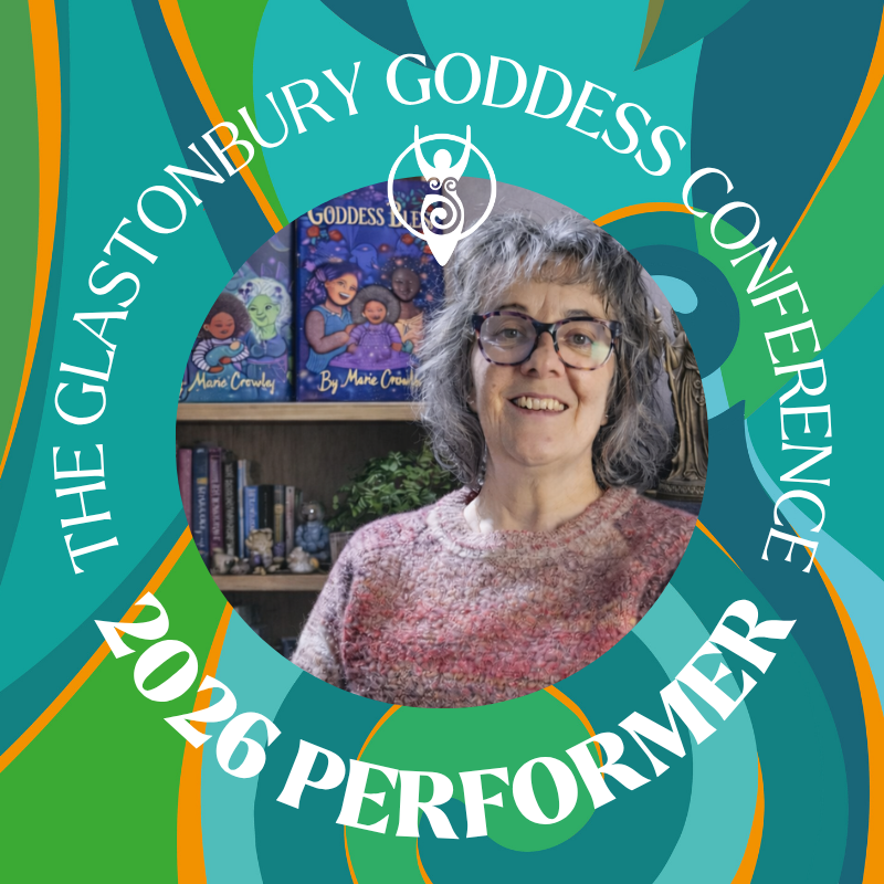 Smiling performer at the Glastonbury Goddess Conference 2026, vibrant background.